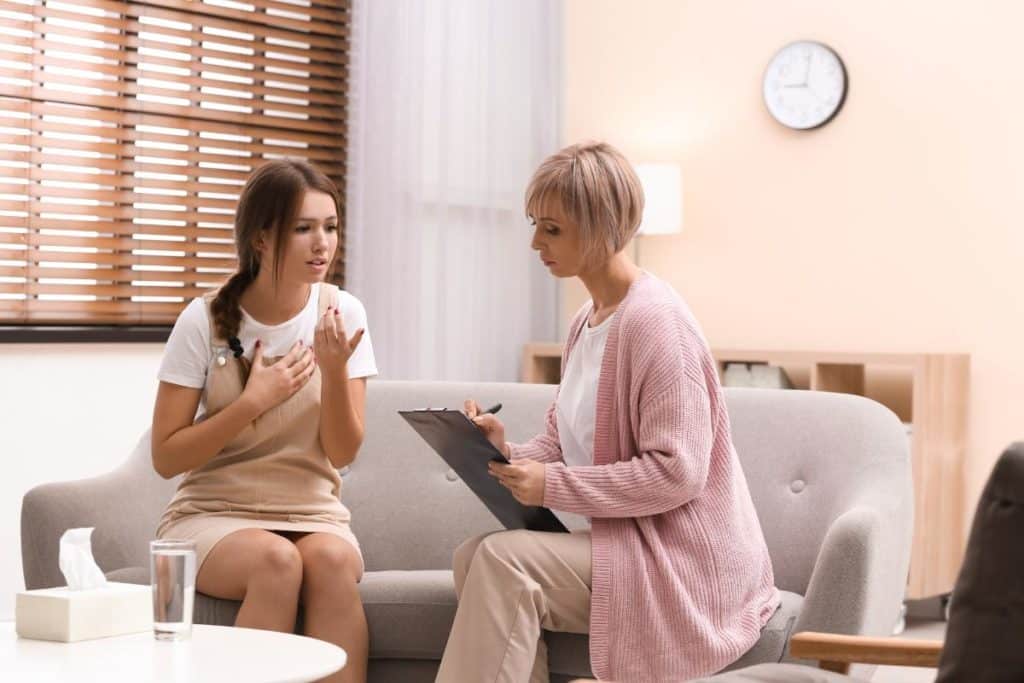 teen talking to therapist in a dialectical behavior therapy session