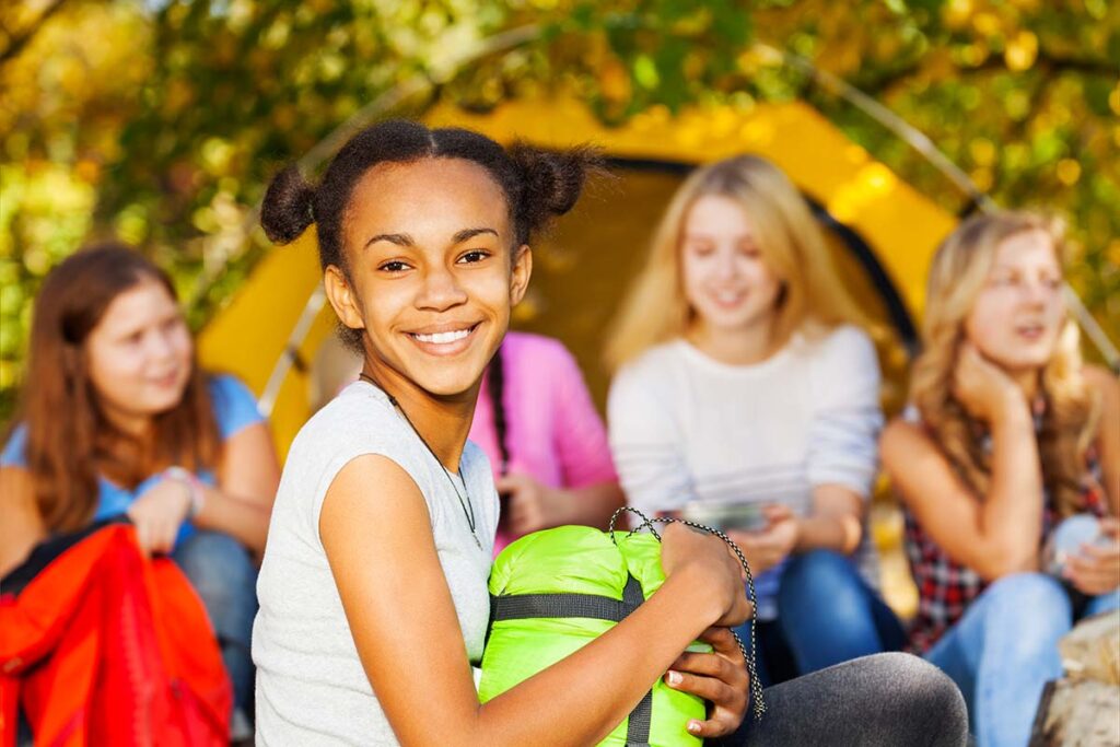 Young girl smiling while participating in CBT group activities for teens