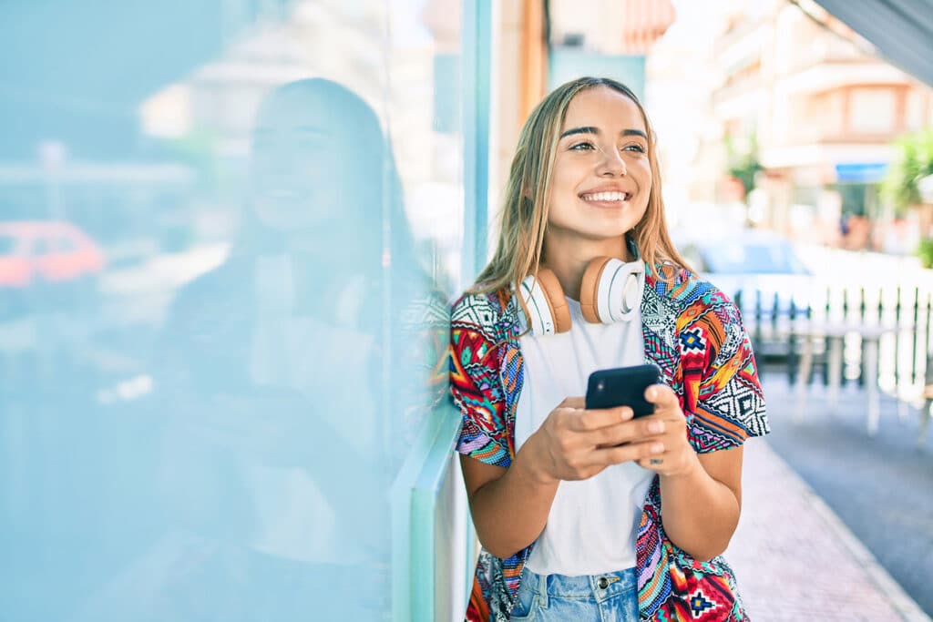 teen smiling while listening to music and participating in activities for bipolar disorder