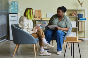 Counselor and teen discussing individual therapy versus group therapy