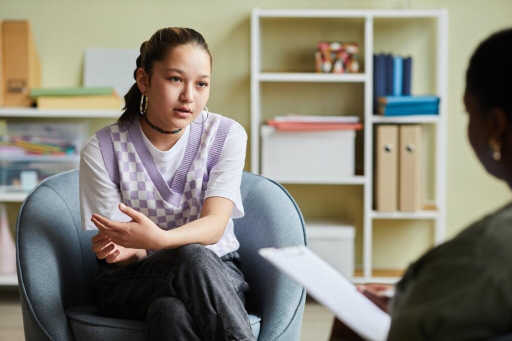 counselor in session with teen assessing signs your teen needs therapy