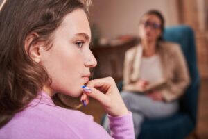 adolescent with concerned look on face while in session with counselor wondering how anxiety treatment can help