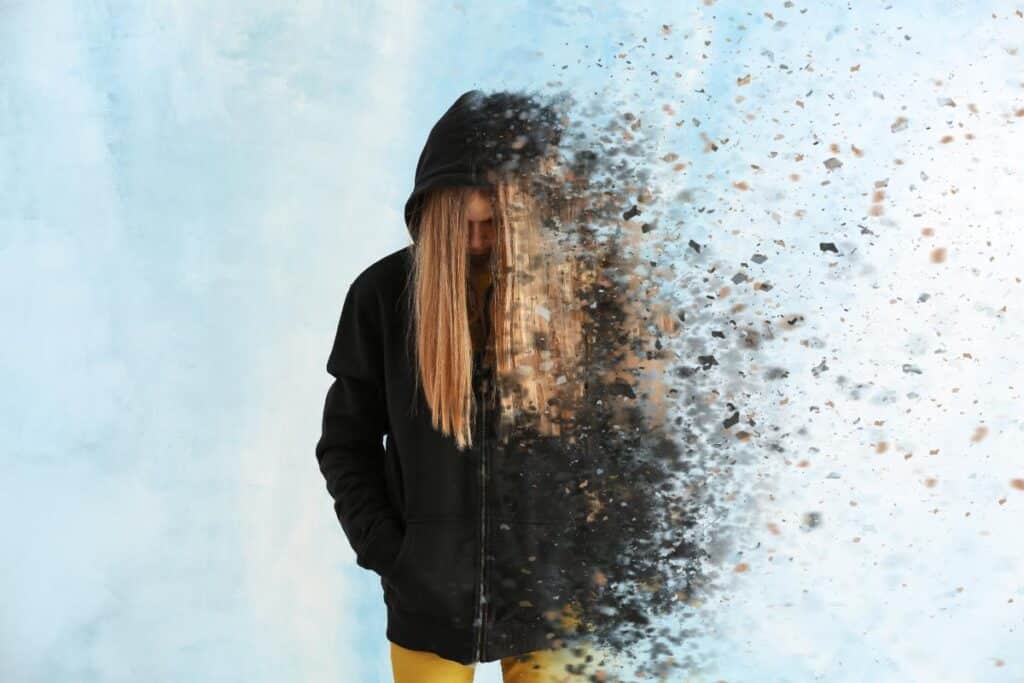 abstract image of teenager becoming fragments to illustrate signs of trauma in teenagers