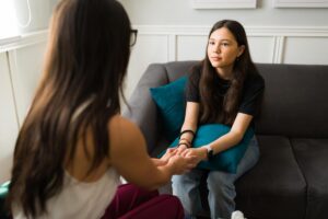adolescent talking to counselor during individual therapy for teenagers