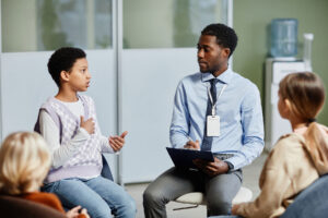 counselor speaking with children to let them know what to expect during family therapy